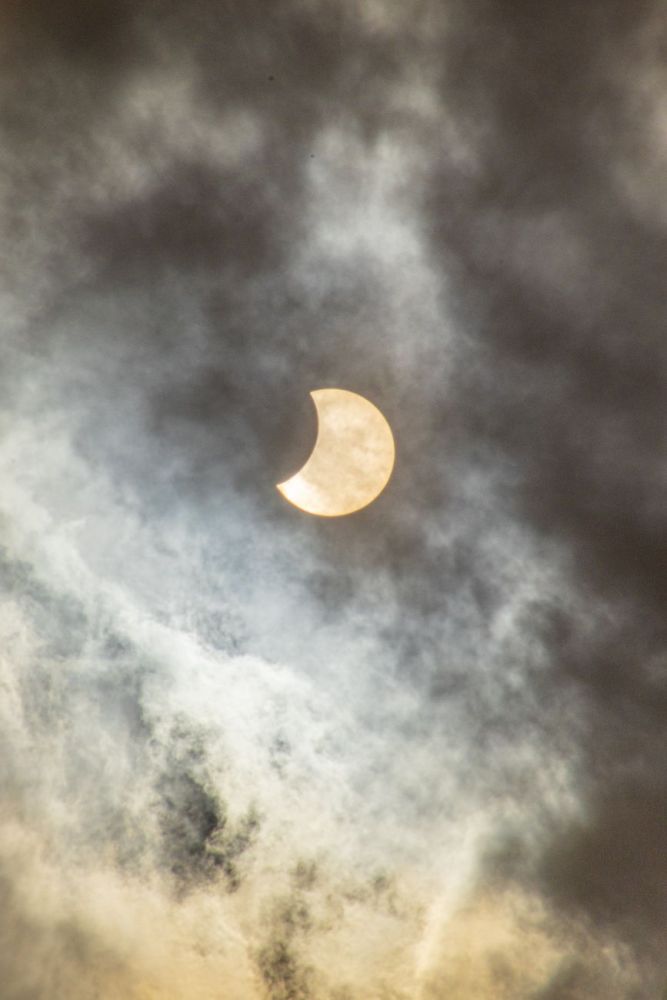 solar eclipse in the cloudy sky